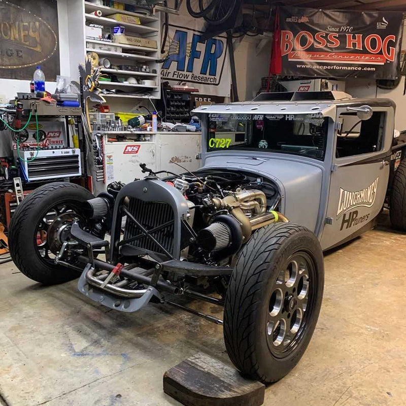 Silver rat rod with exposed engine