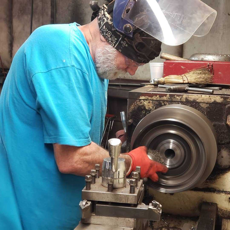 Technician machining a torque converter